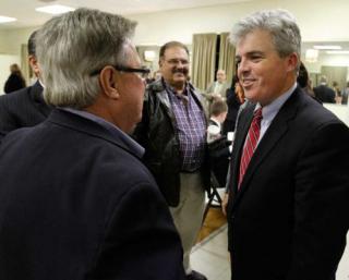hoto by John Dunn | Newly elected Suffolk County Executive Steve Bellone, right, greets Chamber of Commerce members from across Suffolk County at a small business roundtable Monday at the VFW in Kings Park.